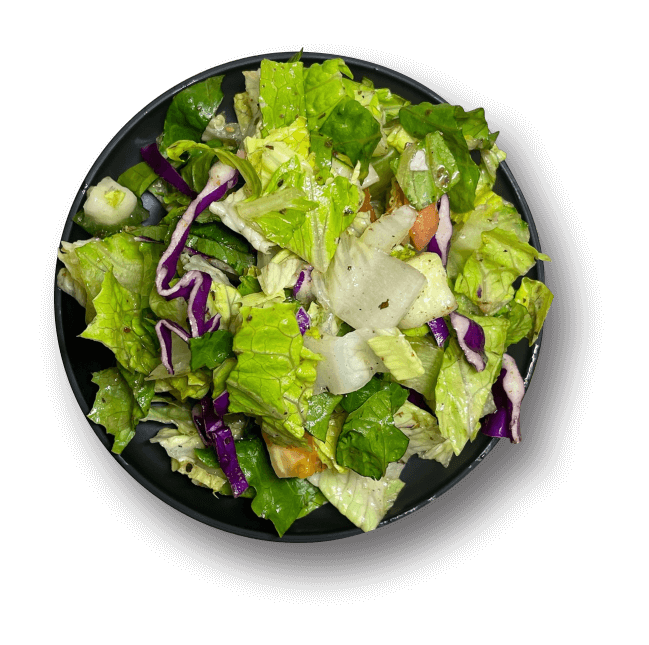 A black plate showcasing a fresh salad with mixed greens and vibrant vegetables.